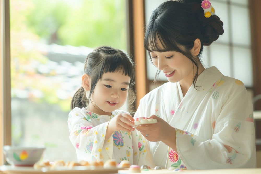 Japanese mother and daughter decorating summer cookies child robe togetherness.