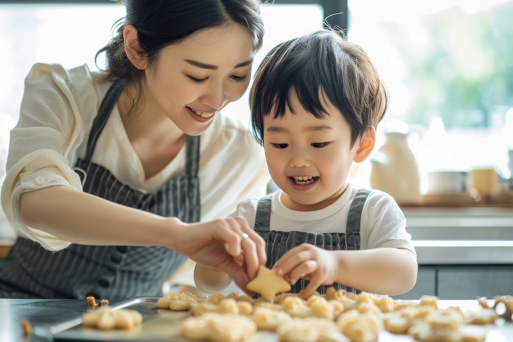 Japanese mother and son decorating summer cookies cooking adult baby.