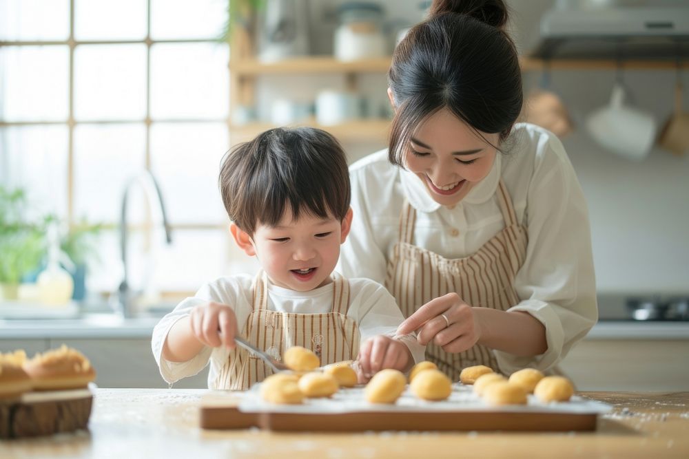 Japanese mother and son decorating donuts adult baby food.