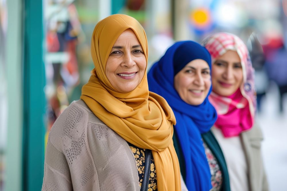 Three Muslim mature woman shopping together adult scarf smile.