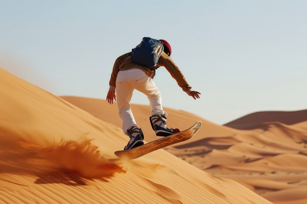 Tourist Sandboarding man in the Desert snowboarding recreation skateboard.