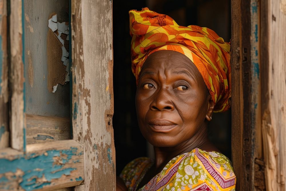 African mature woman looking over the door adult architecture tradition.