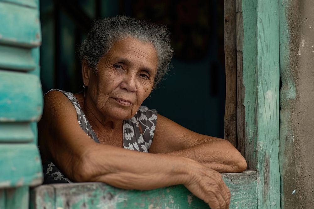Cuban mature woman looking over the door adult contemplation homelessness.