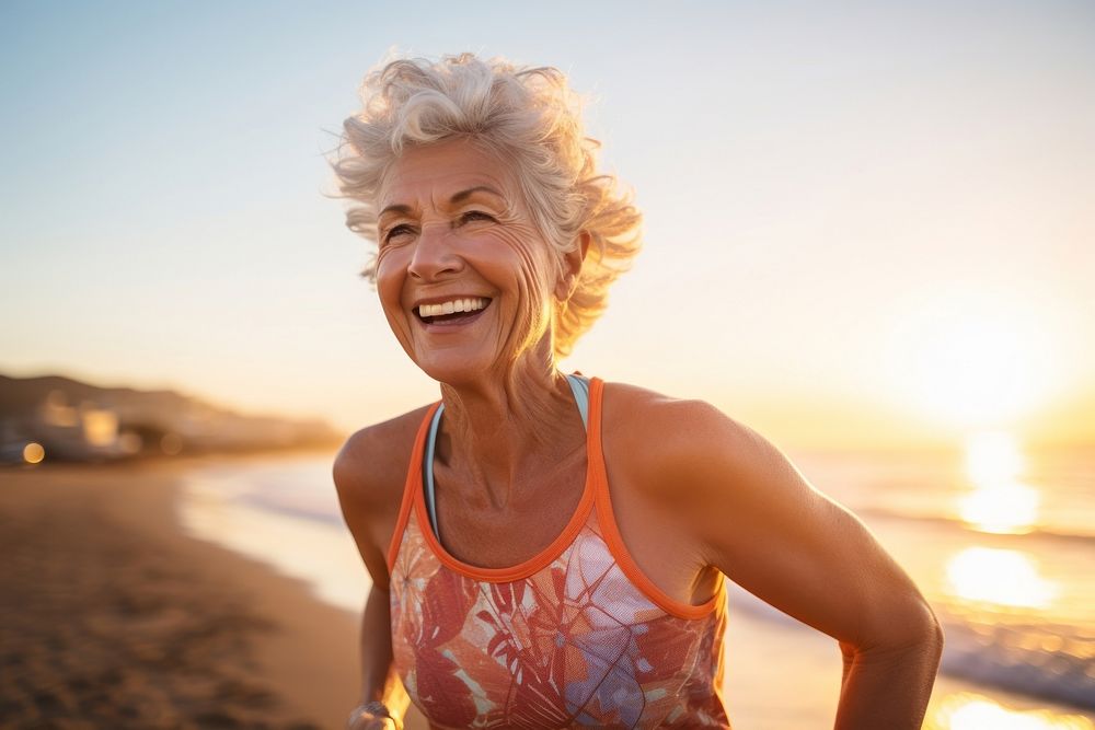 Elderly woman running smile laughing beach.
