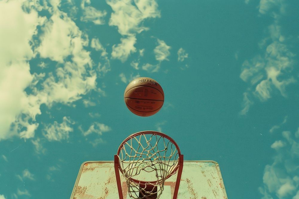 Basketball rim with basketball outdoors sports sky.