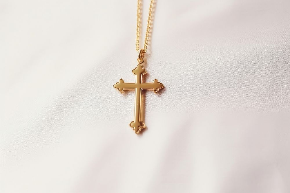 Golden chirstian cross crucifix pendant symbol.