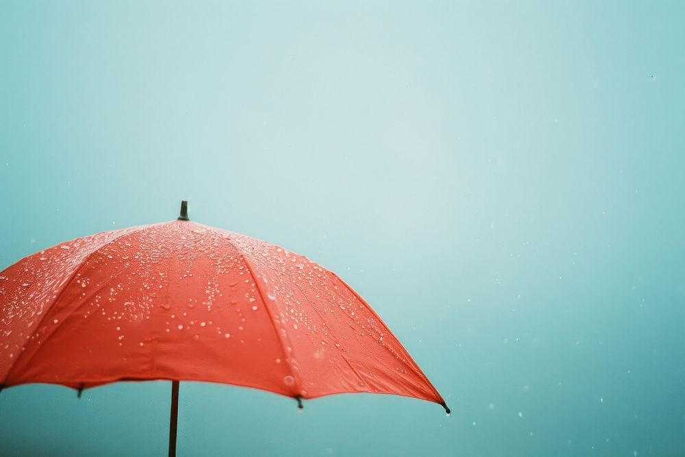 Umbrella protection sheltering raindrop.