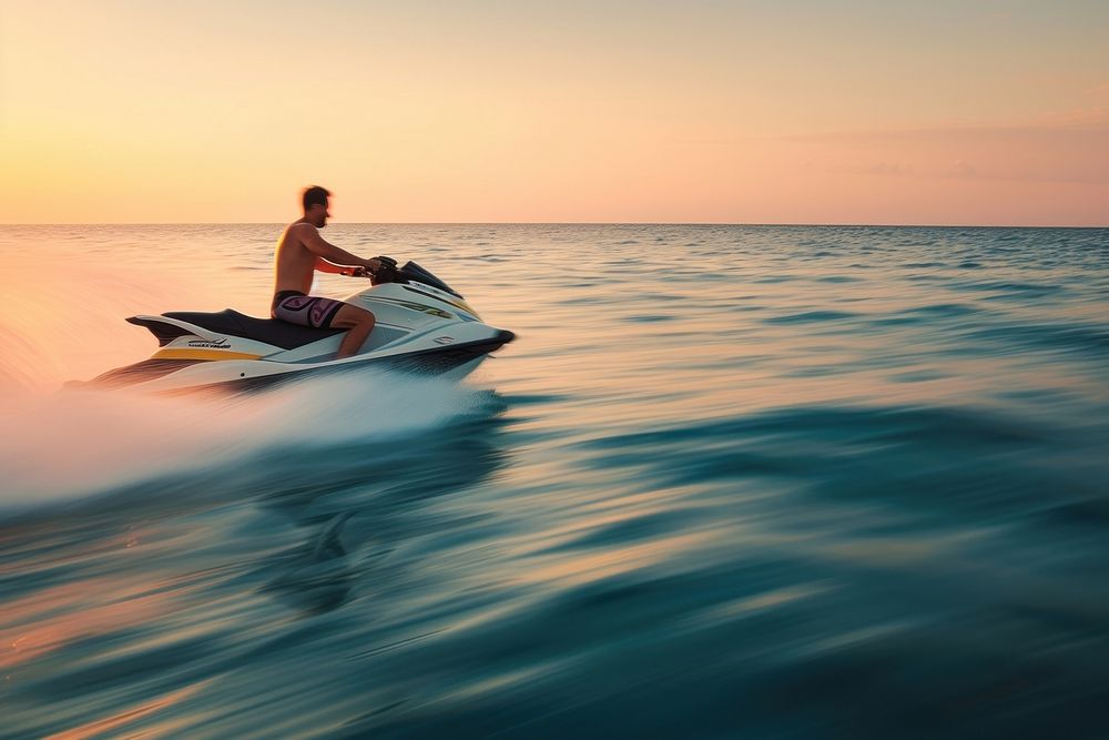 Attractive man riding a aquabike at sunset vehicle sports adult.
