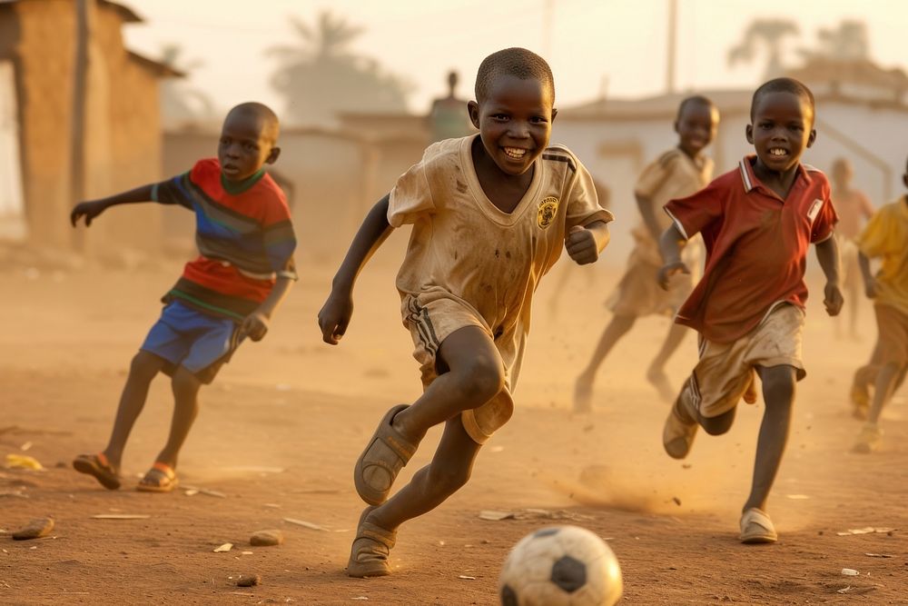 Black kids playing soccer football running sports.