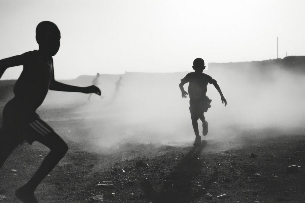 Black kids playing soccer outdoors running black.