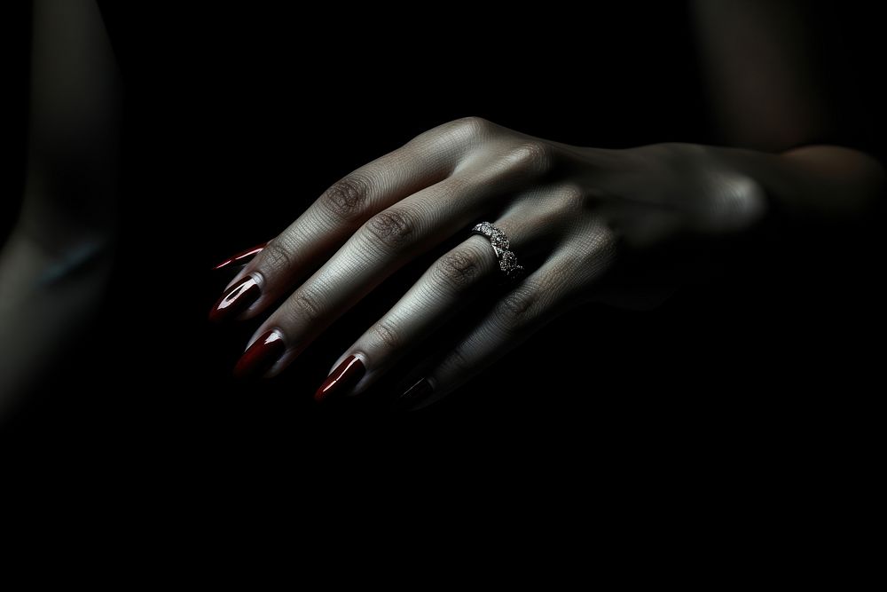 Woman hand with red nail monochrome jewelry finger.