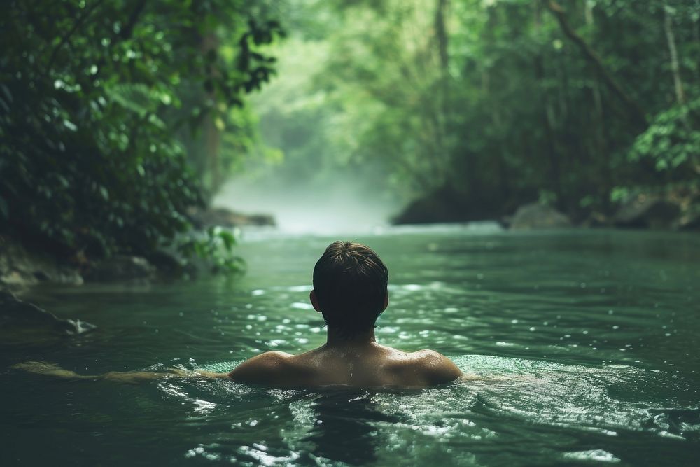 Man swiming in river at rain forest swimming outdoors bathing.