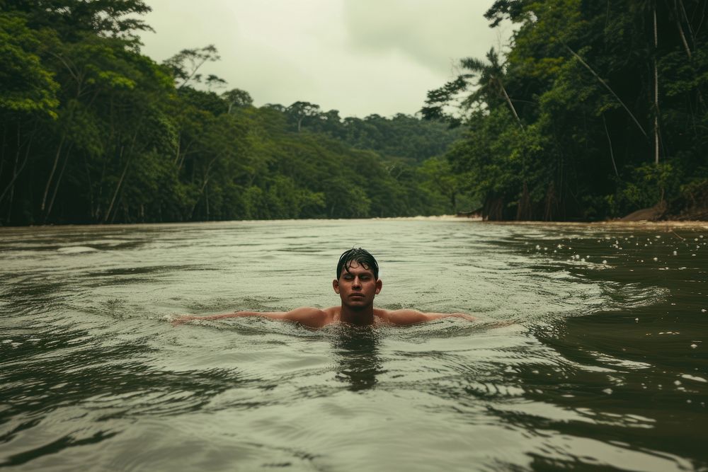Man swiming in river at rain forest swimming outdoors nature.