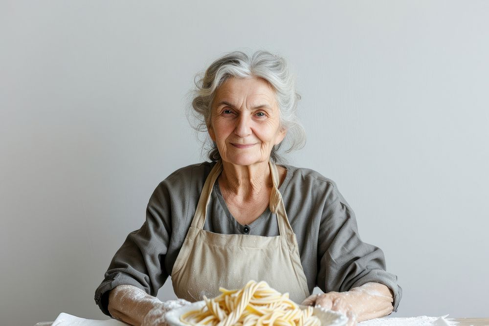 Mature woman watching tutorials for making pasta adult food retirement.