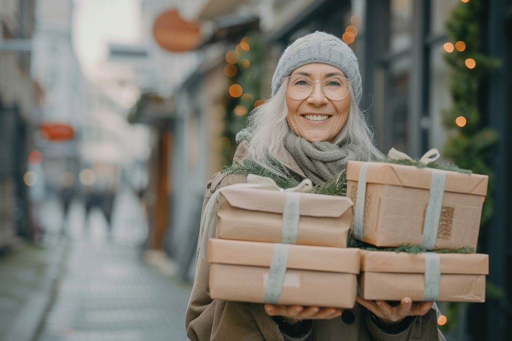 A joyful mature woman with a stack boxes holiday smile adult.