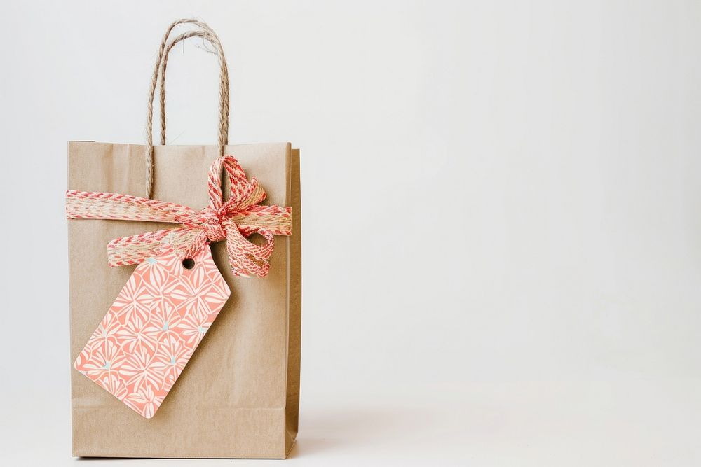 Shopping bag and gift with sale label handbag white background celebration.