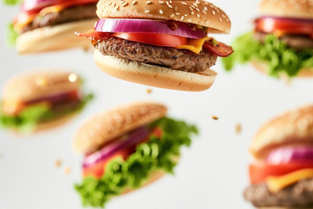 Photo of flying hamburgers food vegetable condiment.