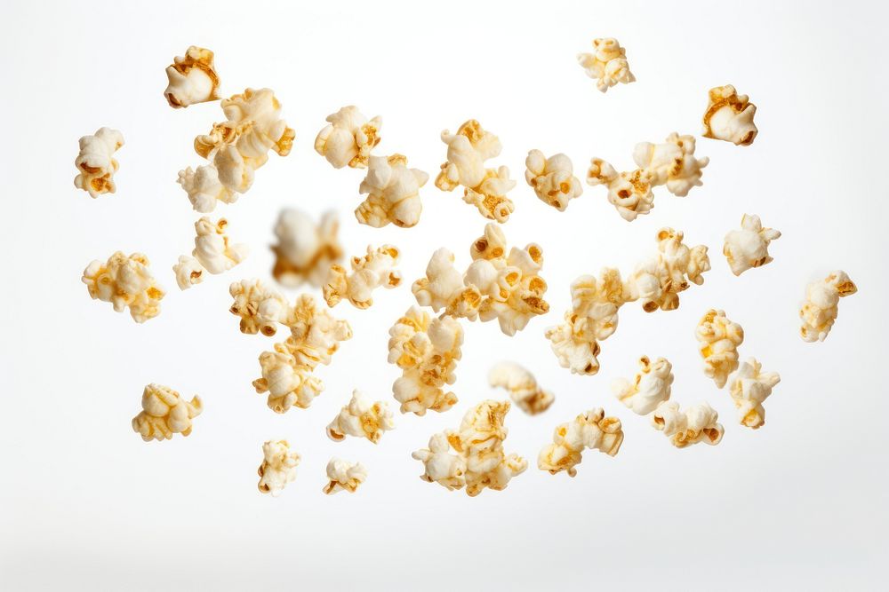 Photo of flying popcorns snack food white background.