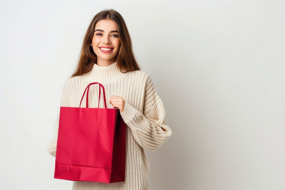 Happy women holding shopping bag sweater white background consumerism.