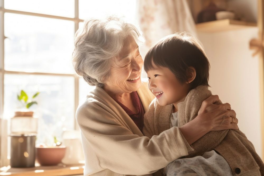 Japanese little boy hug her grandmother adult affectionate togetherness.
