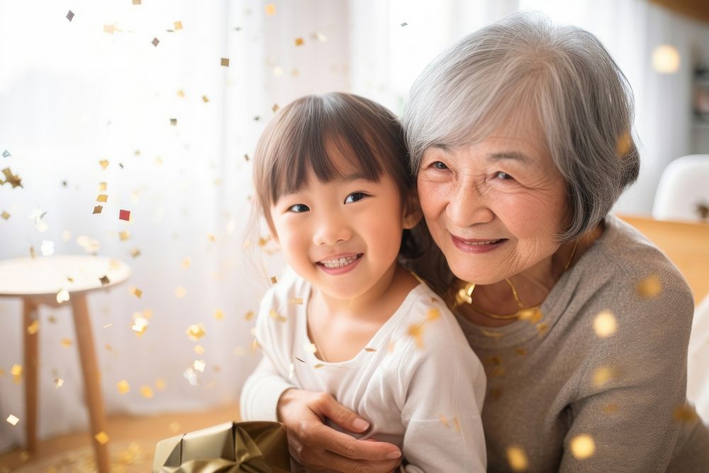 Japanese little girl hug her grandmother family togetherness affectionate.
