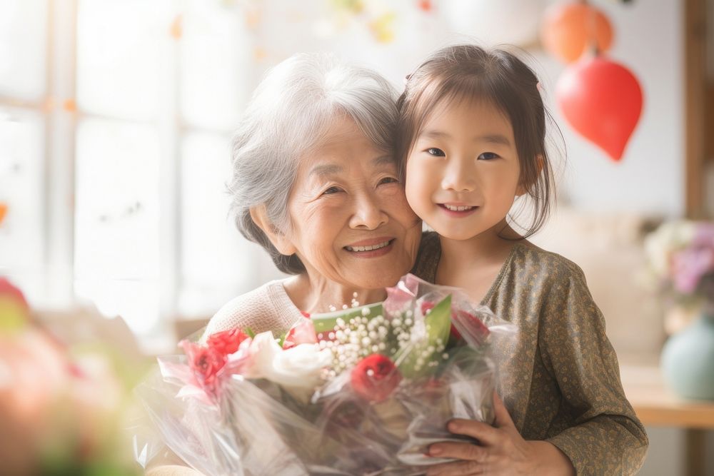 Japanese little girl hug her grandmother flower adult child.