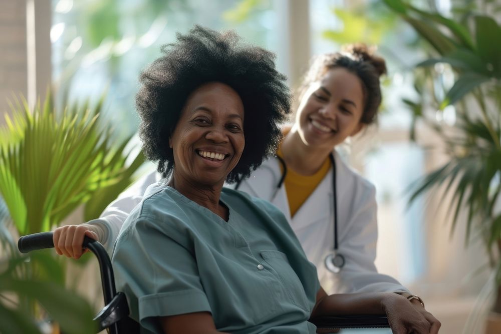Joyful mature black woman sitting on wheelchair nurse smile female.