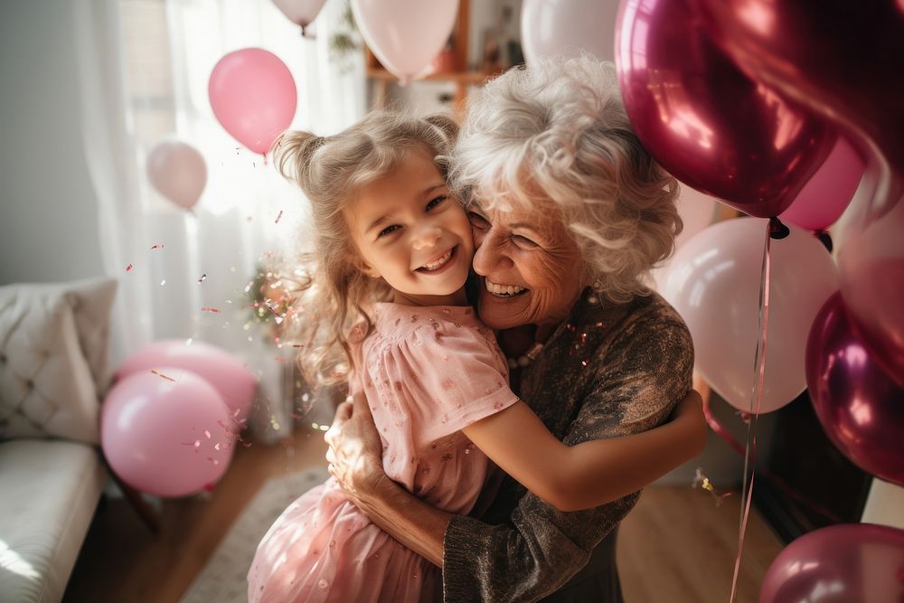 Little girl hug her grandmother party birthday portrait.