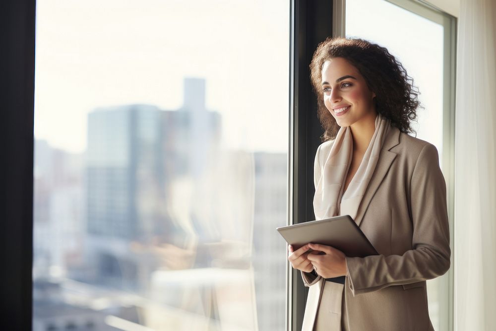 Business woman standing smiling holding.