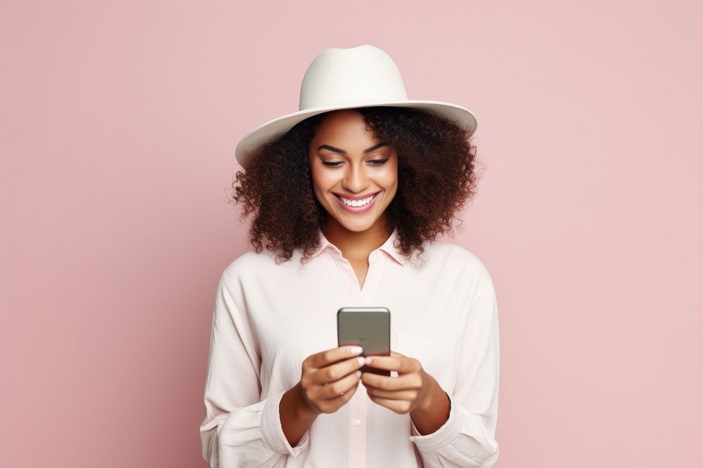 Young adult smiling happy pretty latin woman holding mobile phone device portrait smile photo.