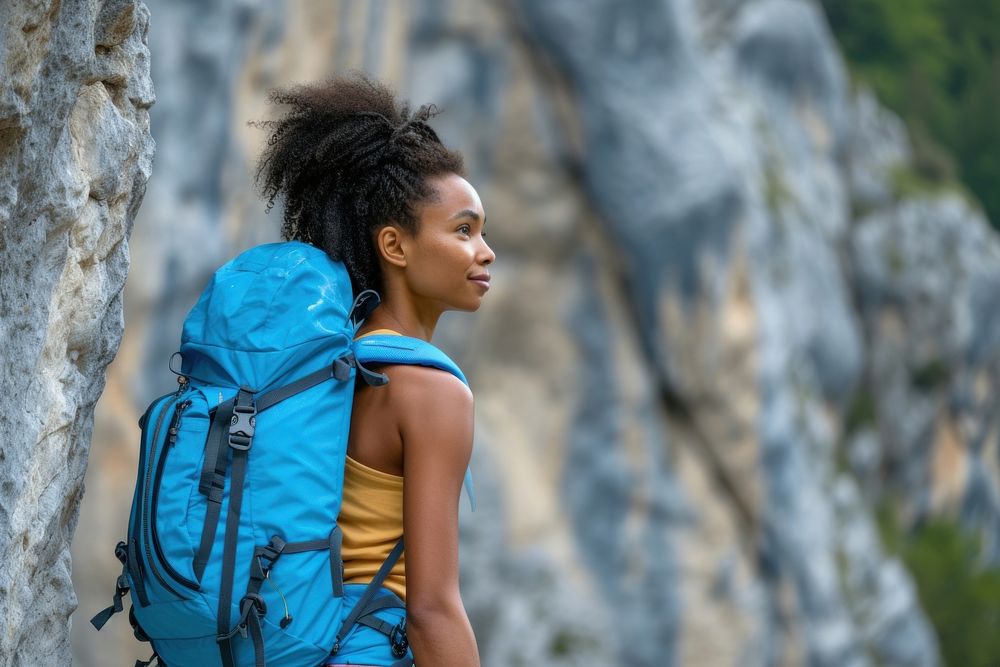 Black young slim woman rock climber backpack backpacking climbing.
