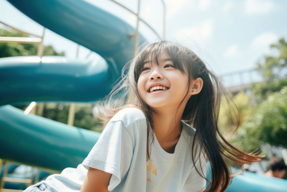Asian girl relax and smile playground laughing outdoors.