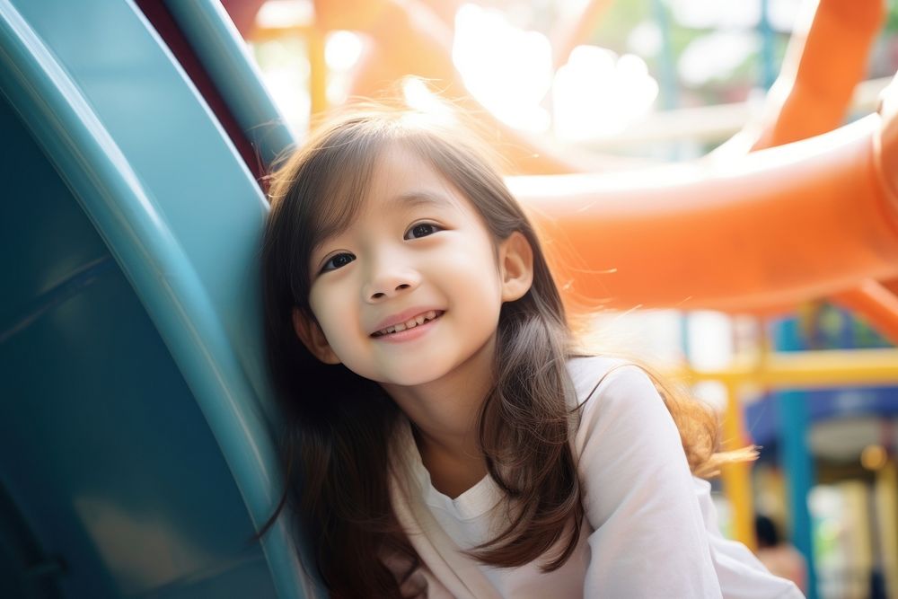 Asian girl relax and smile playground child happiness.