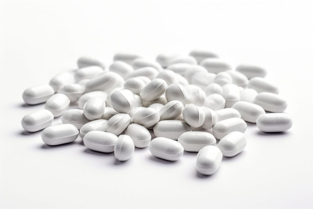 Pills white powder capsules white background medication abundance.