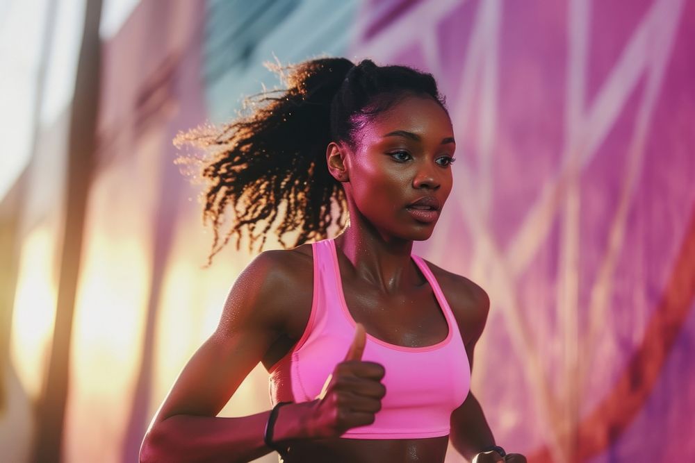 Black female athlete is running adult determination exercising.