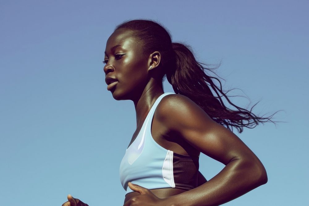 Black female athlete is running determination competition exercising.