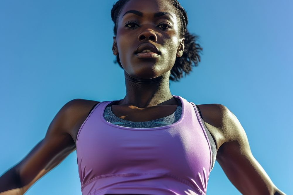 Black female athlete is running determination athleticism motivation.