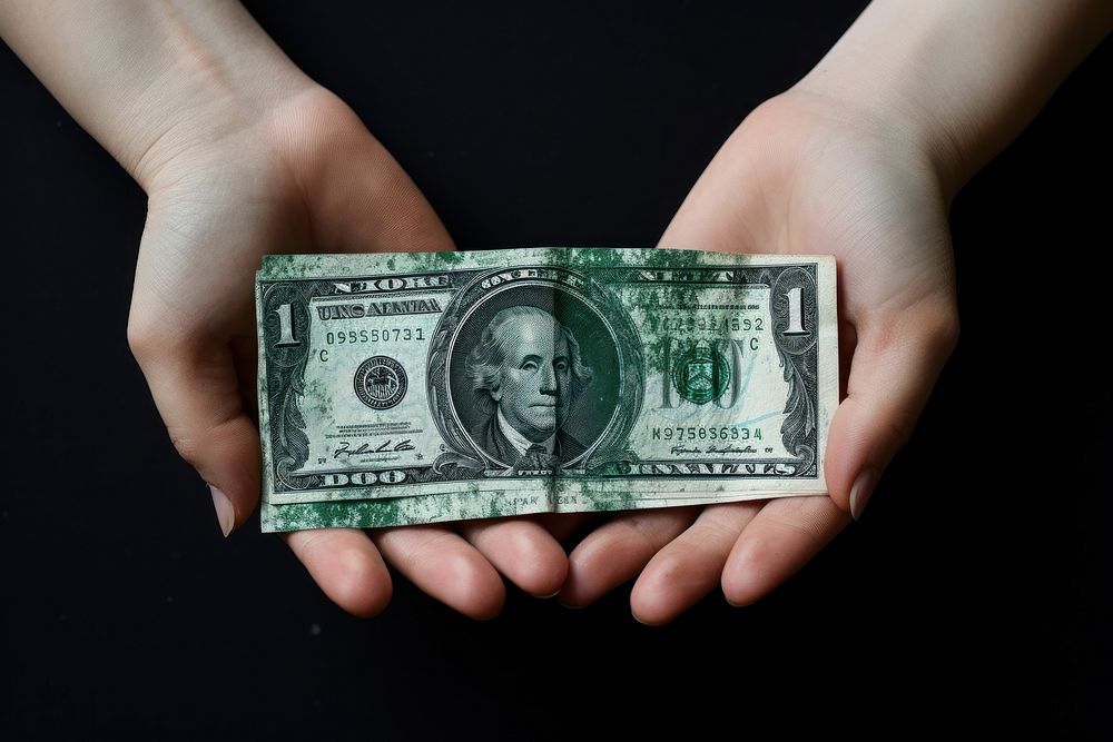 Money holding dollar paper.