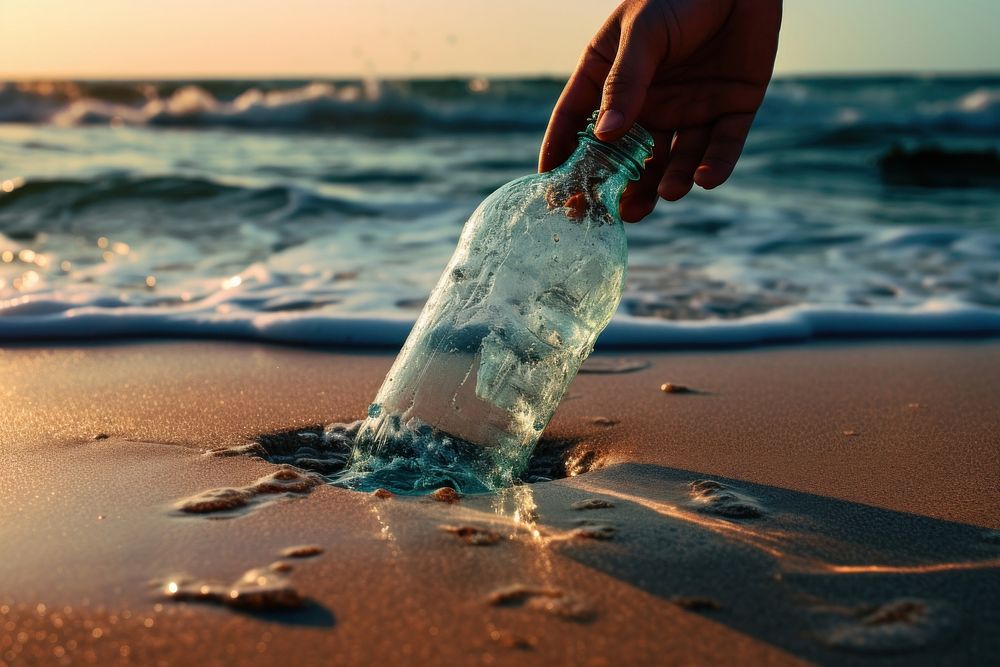 Dropping bottle put on beach with sea water outdoors nature ocean.
