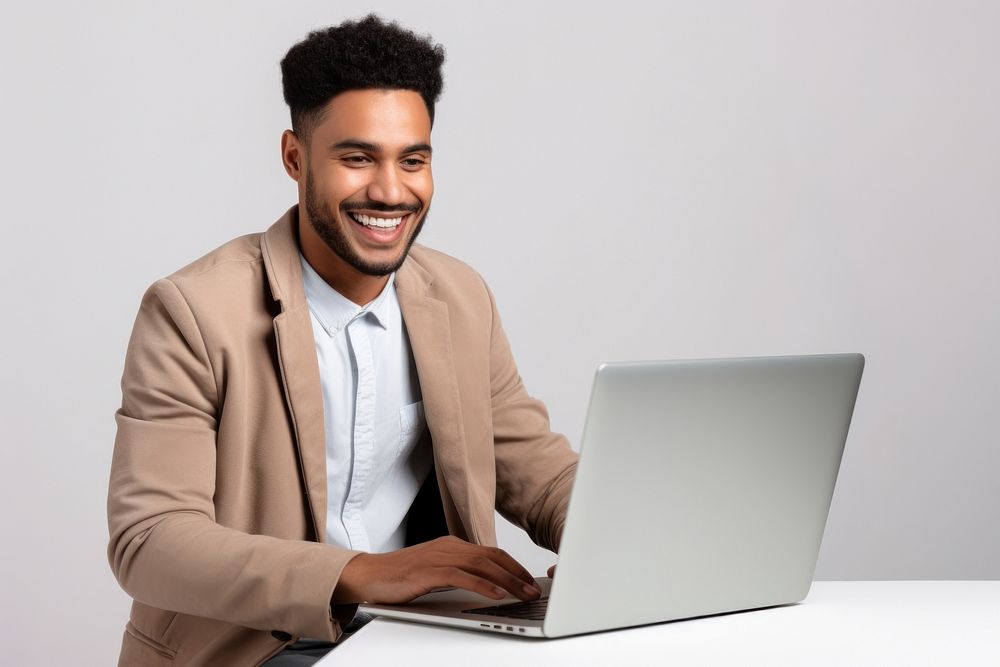 Man works laptop computer smiling.
