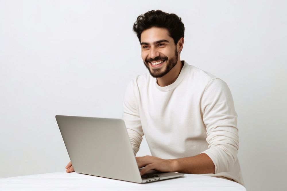 Man works laptop computer smiling.