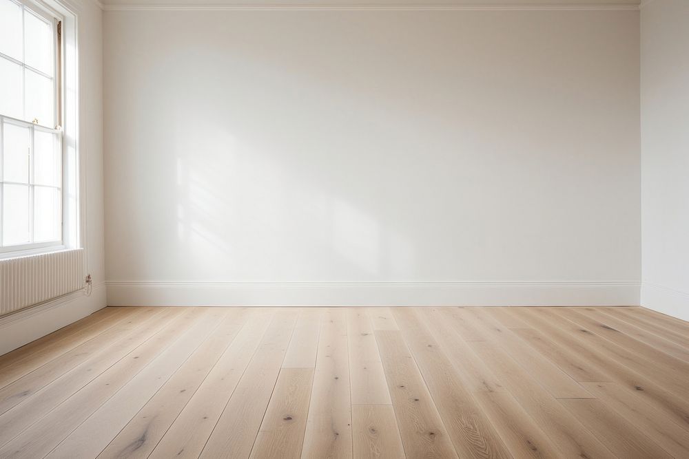 Gary wall in an empty room with a wooden floor flooring hardwood architecture.