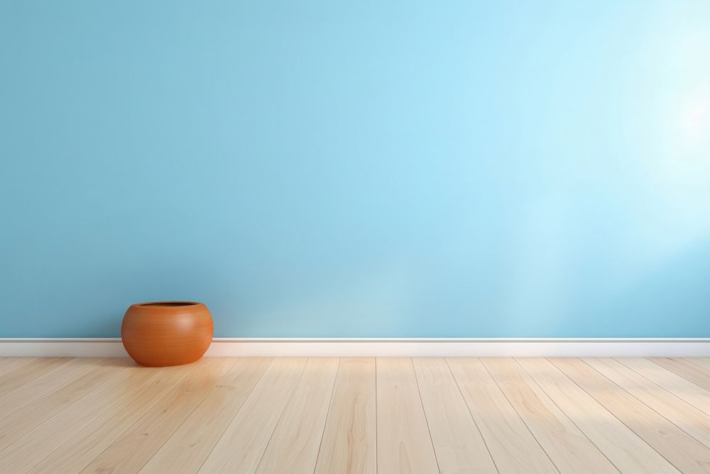 Light blue wall in an empty room with a wooden floor architecture flooring tranquility.