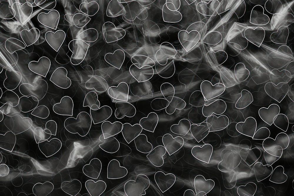 Plastic wrap with heart patterns backgrounds black smoke.
