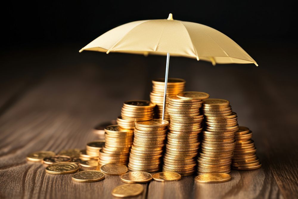 Umbrella covering stack of coins umbrella money gold.