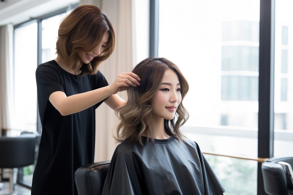 Hairdresser styling hair customer adult hairstyle.