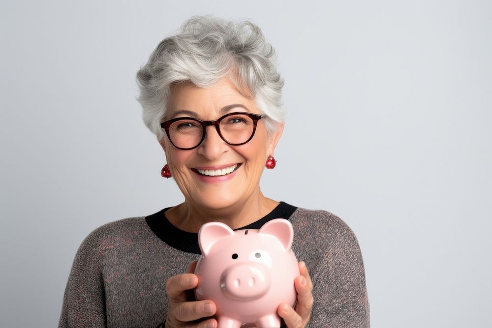 Woman holding his piggy bank portrait smile happy.