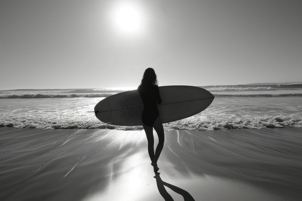 A woman carry surfboard beach outdoors surfing.
