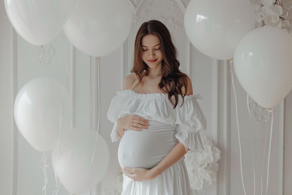 White pregnant holding photo of baby ultrasound balloon adult dress.