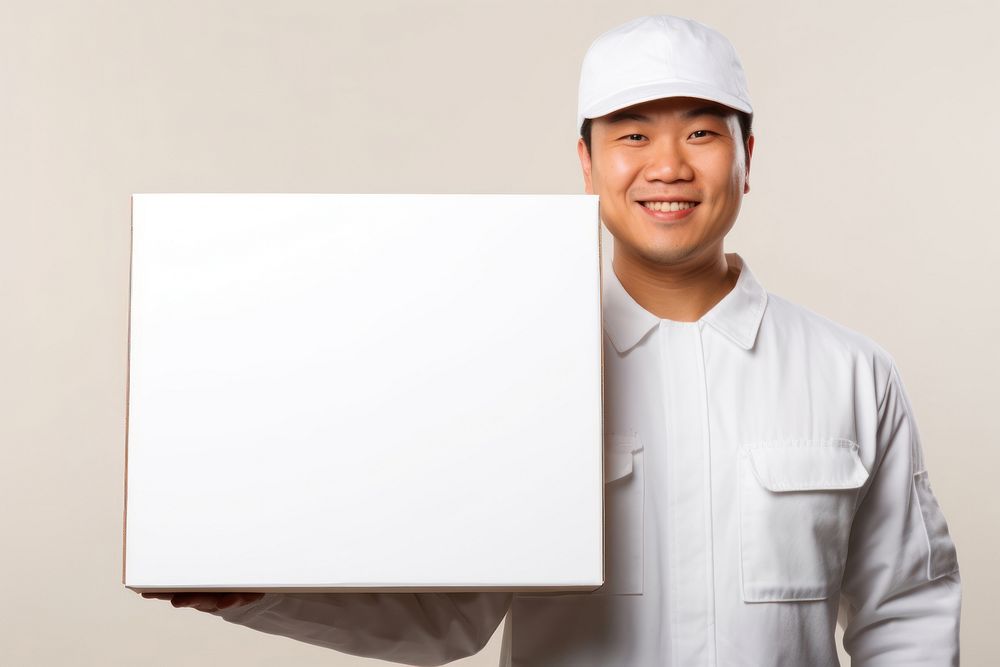 Japanese delivery man holding blank white box portrait adult photo.